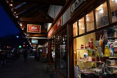 27B There Are Many Shops Along Banff Avenue With The Lights On After Sunset In Winter.jpg